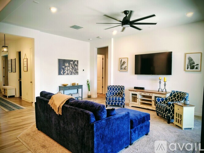 A living room with a grey couch and a yellow chair.