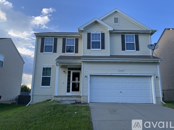 A two-story house with a garage is available for rent.