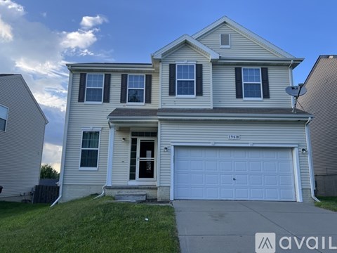 A two-story house with a garage is available for rent.