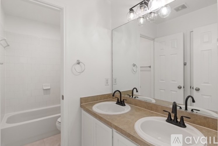 A bathroom with a large mirror above two sinks.