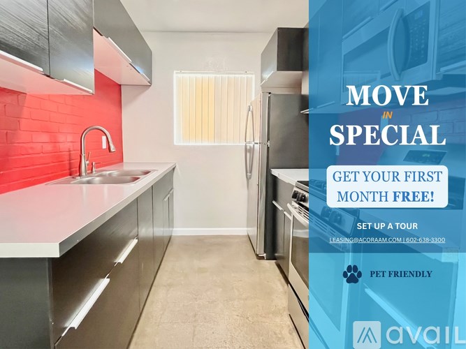 A kitchen with a red wall and a sign offering a free first month.