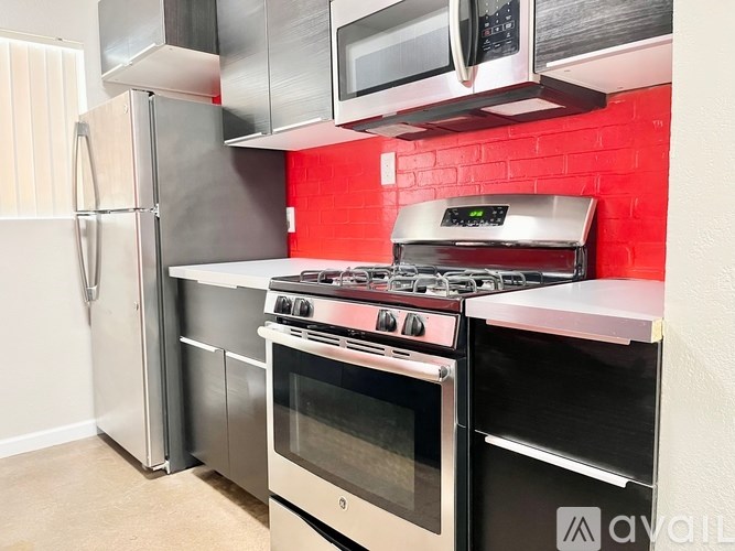 A kitchen with a stove, oven, and refrigerator.