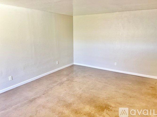 A room with a light-colored wall and floor.