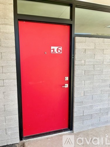 A red door with the number 16 on it.