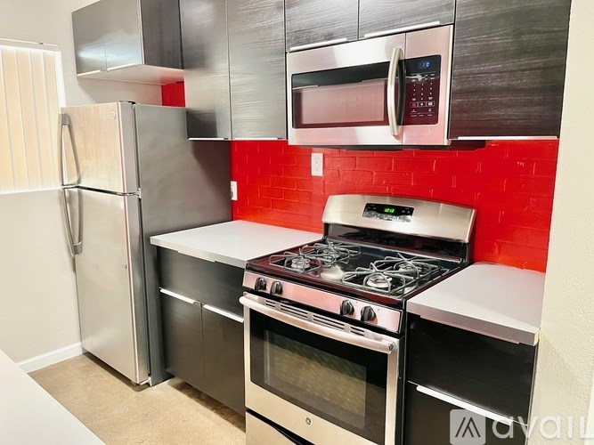 A kitchen with a stove, oven, and refrigerator.