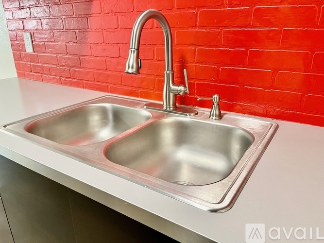 A stainless steel double sink in a kitchen.