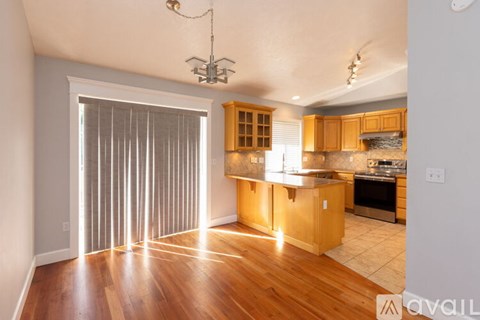 A kitchen with wooden cabinets and a stainless steel oven.
