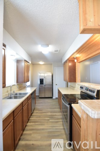 A kitchen with wooden cabinets and a white counter top.