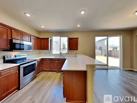 A kitchen with wooden cabinets and a stainless steel oven.