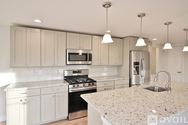 A kitchen with granite countertops and stainless steel appliances.
