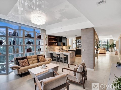 A modern living room with a large sofa and a coffee table.