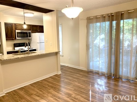 A kitchen with wooden cabinets and a granite countertop.