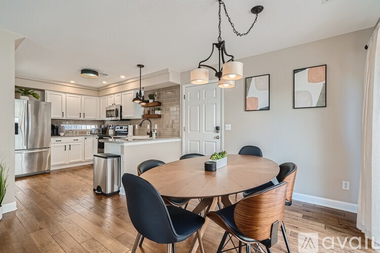A modern kitchen with a dining table and chairs.