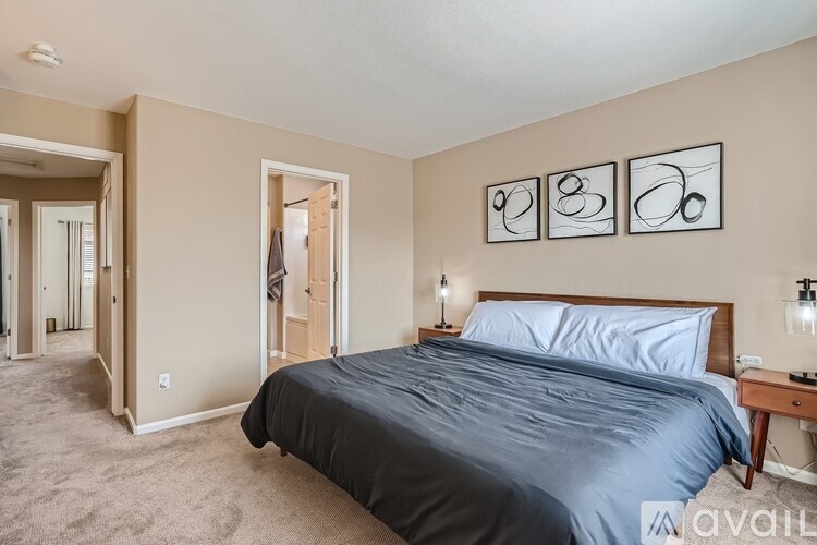 A bedroom with a large bed and a carpeted floor.