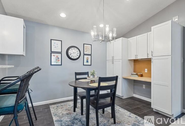 A dining area with a table and chairs.