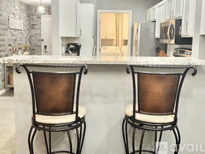 A kitchen with white cabinets and appliances.