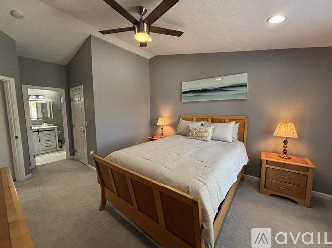 A bathroom with a toilet, sink, and shower curtain.