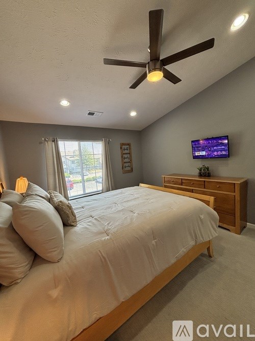 A hallway with white doors and a sign on the wall.