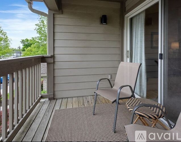 A patio with a chair and a table.
