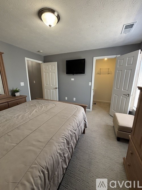 A house with a swimming pool surrounded by trees.
