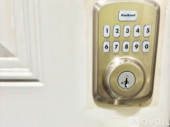 A hallway with a mirror and a bench with a plant on it.