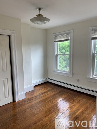 A room with wooden floors and white walls.