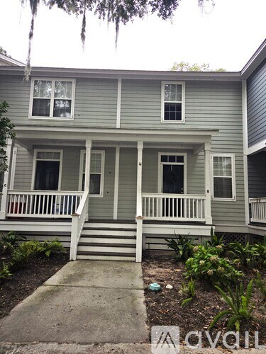 A two-story house with a front porch.