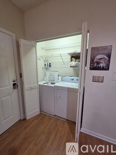 A small room with a cabinet and a poster of an eagle.
