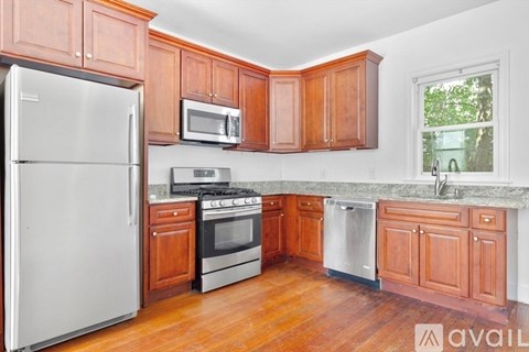 A kitchen with wooden cabinets and a white refrigerator.