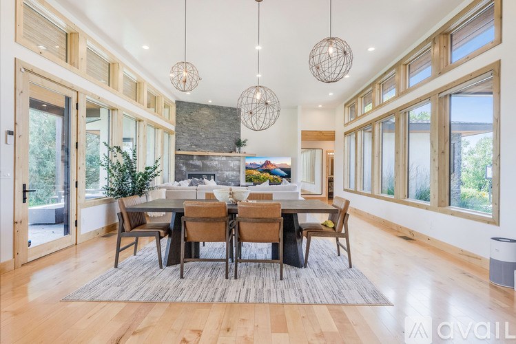 A modern dining room with a large table and chairs.