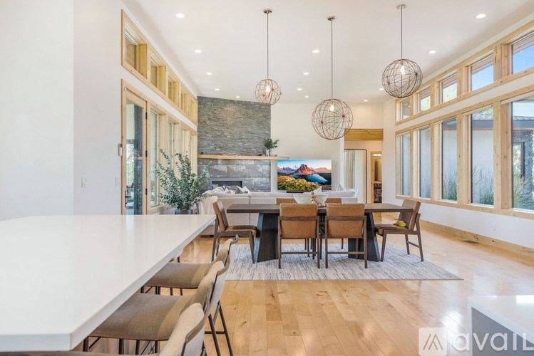 A modern dining room with a large table and chairs.