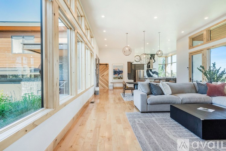 A modern living room with wooden floors and furniture.