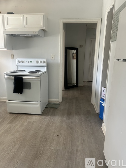 A kitchen with a white stove and a white oven.