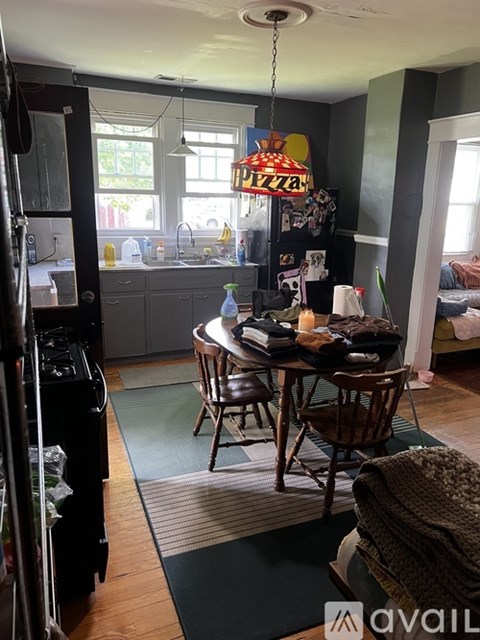 A kitchen with a table and chairs in the middle of the room.