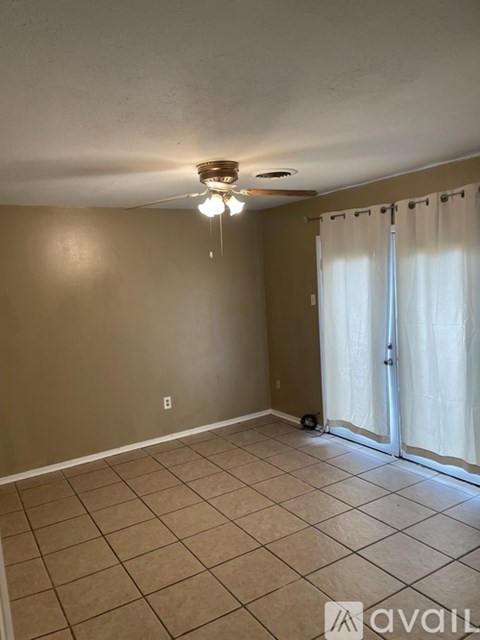 A room with beige walls and a tiled floor.