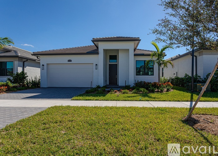 A house with a garage door is for sale.