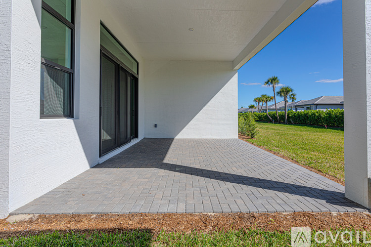 A modern house with a white exterior and a glass door.
