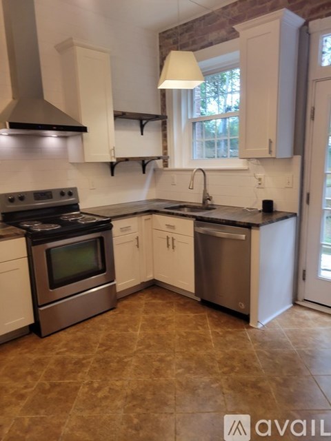 A kitchen with a stove top oven and a dishwasher.