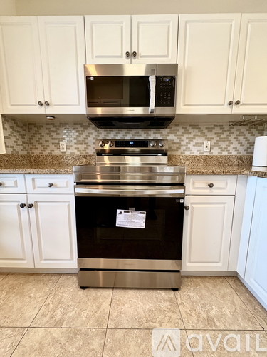 A kitchen with a stove top oven and microwave above it.