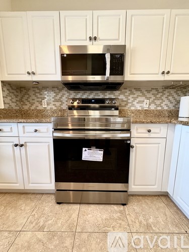 A kitchen with a stove top oven and microwave above it.
