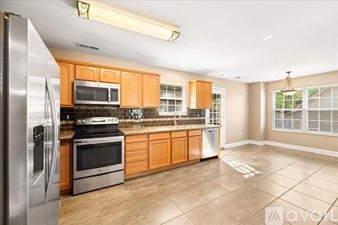 A kitchen with wooden cabinets and stainless steel appliances.
