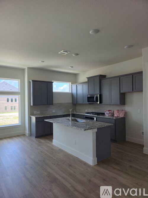 A modern kitchen with a large island in the middle.