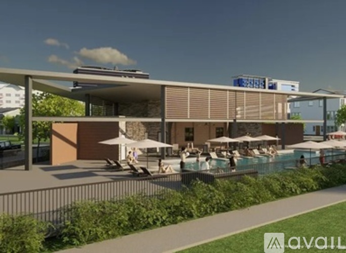 A modern building with a pool in front and a walkway leading to it.