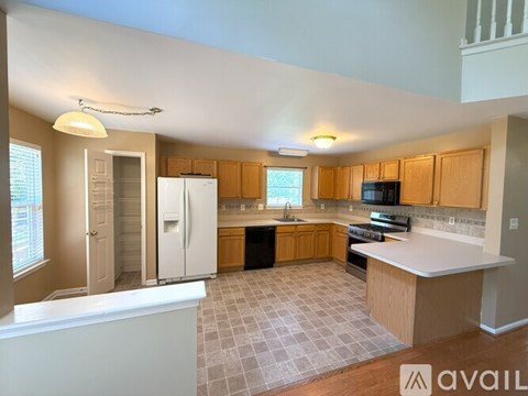 A kitchen with wooden cabinets and a tiled floor.