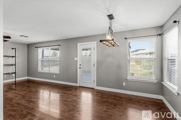 A living room with a grey couch and a wooden coffee table.