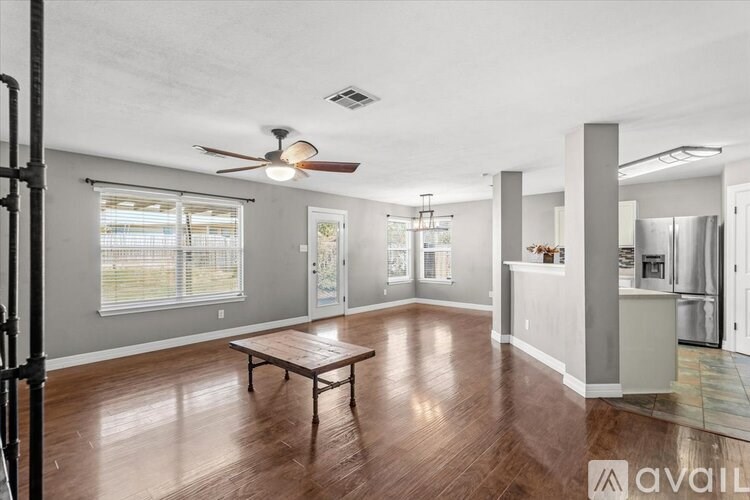 A hallway with a light on the ceiling and a door on the right.