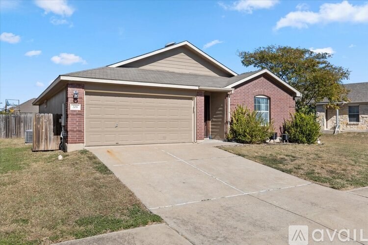 A kitchen with white cabinets and a stone backsplash.