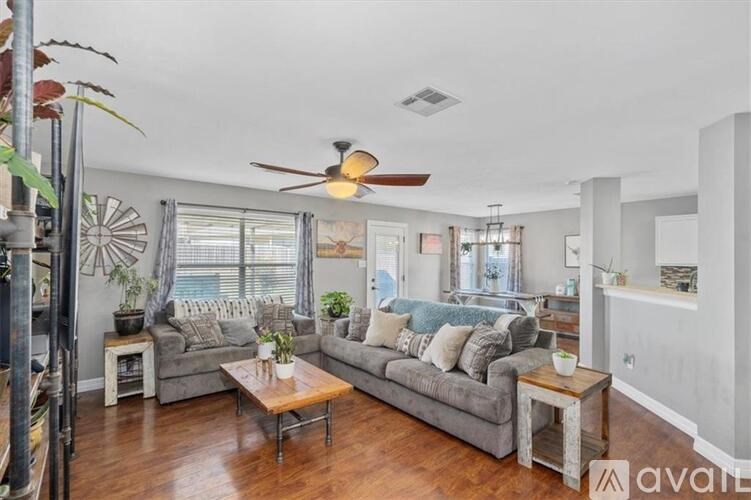 A living room with a grey couch and a wooden coffee table.