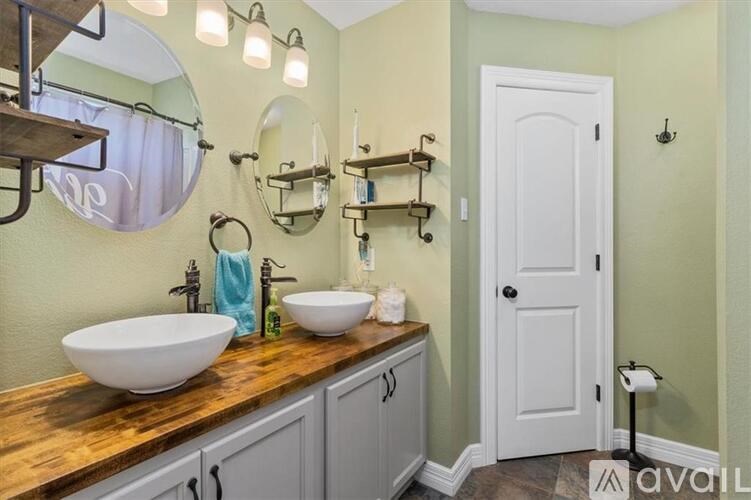 A bathroom with a white sink and a mirror above it.