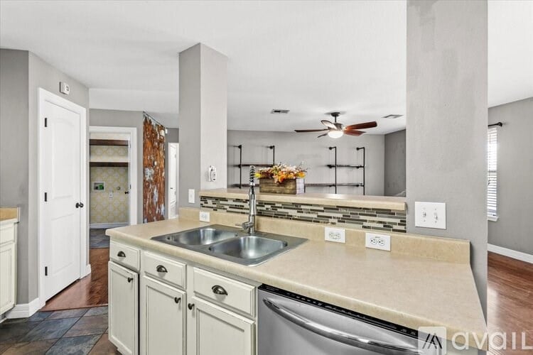 A white bathtub with a shower head and a window above it.
